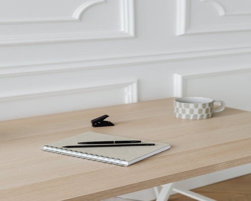 A notebook and pen resting on a neat wooden desk