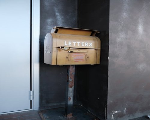 A classic mailbox at a quiet street corner in Mexico City